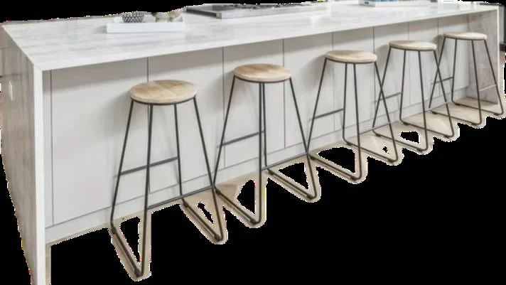 White kitchen island with polished concrete top and five metal bar stools with wood seats